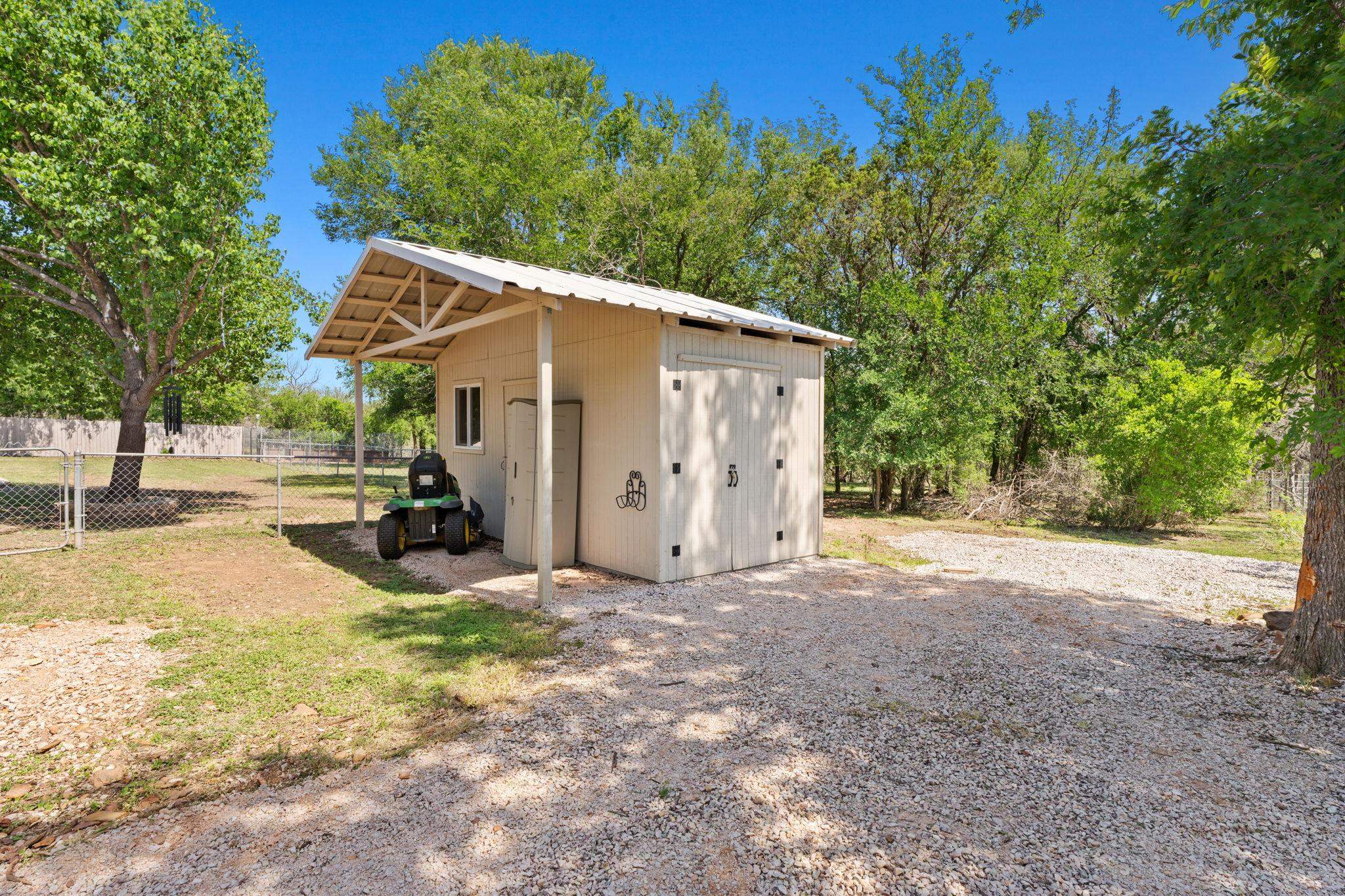 2409 Mormon Mill Road Marble Falls, TX 78654 - Photo 20 of 30 a view of a house with backyard and trees