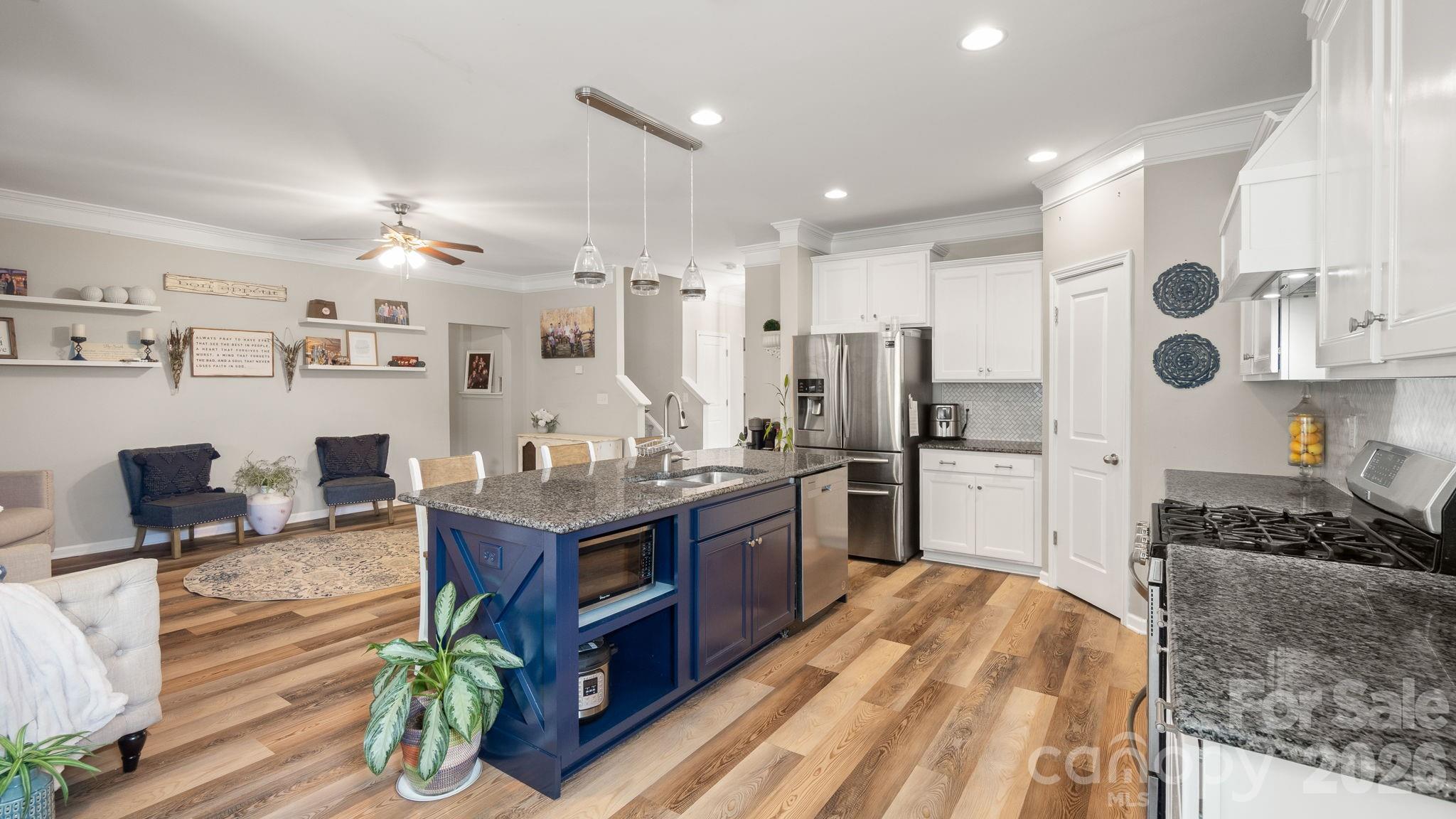 4708 Summerside Drive Clover, SC 29710 - Photo 17 of 48 a kitchen with stainless steel appliances kitchen island granite countertop a stove and a refrigerator