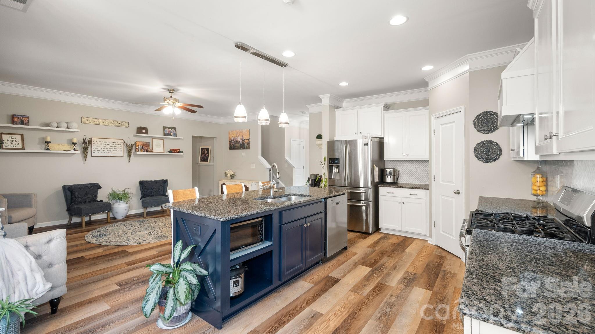 4708 Summerside Drive Clover, SC 29710 - Photo 19 of 48 a kitchen with stainless steel appliances kitchen island granite countertop a stove refrigerator and cabinets