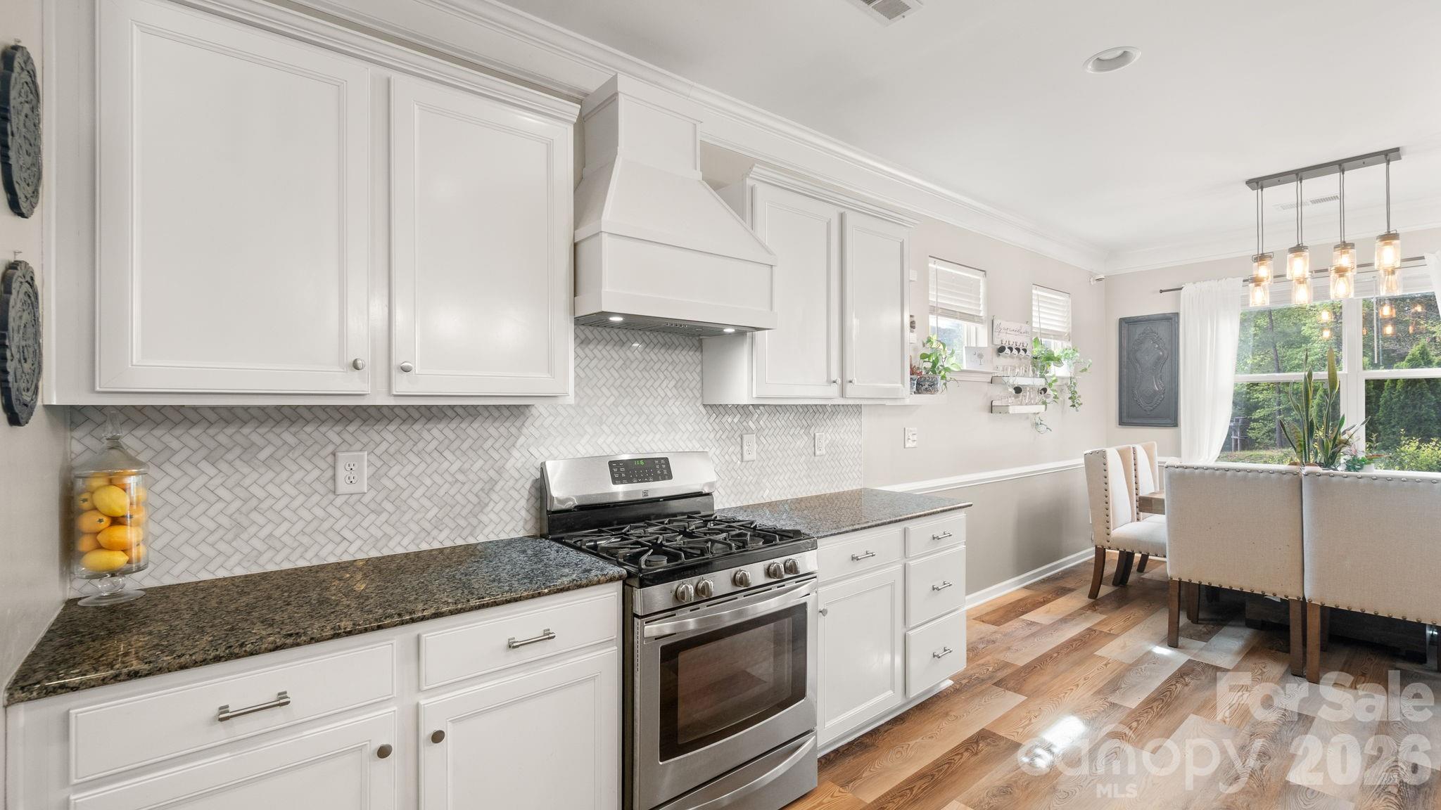 4708 Summerside Drive Clover, SC 29710 - Photo 21 of 48 a kitchen with granite countertop white cabinets and white appliances