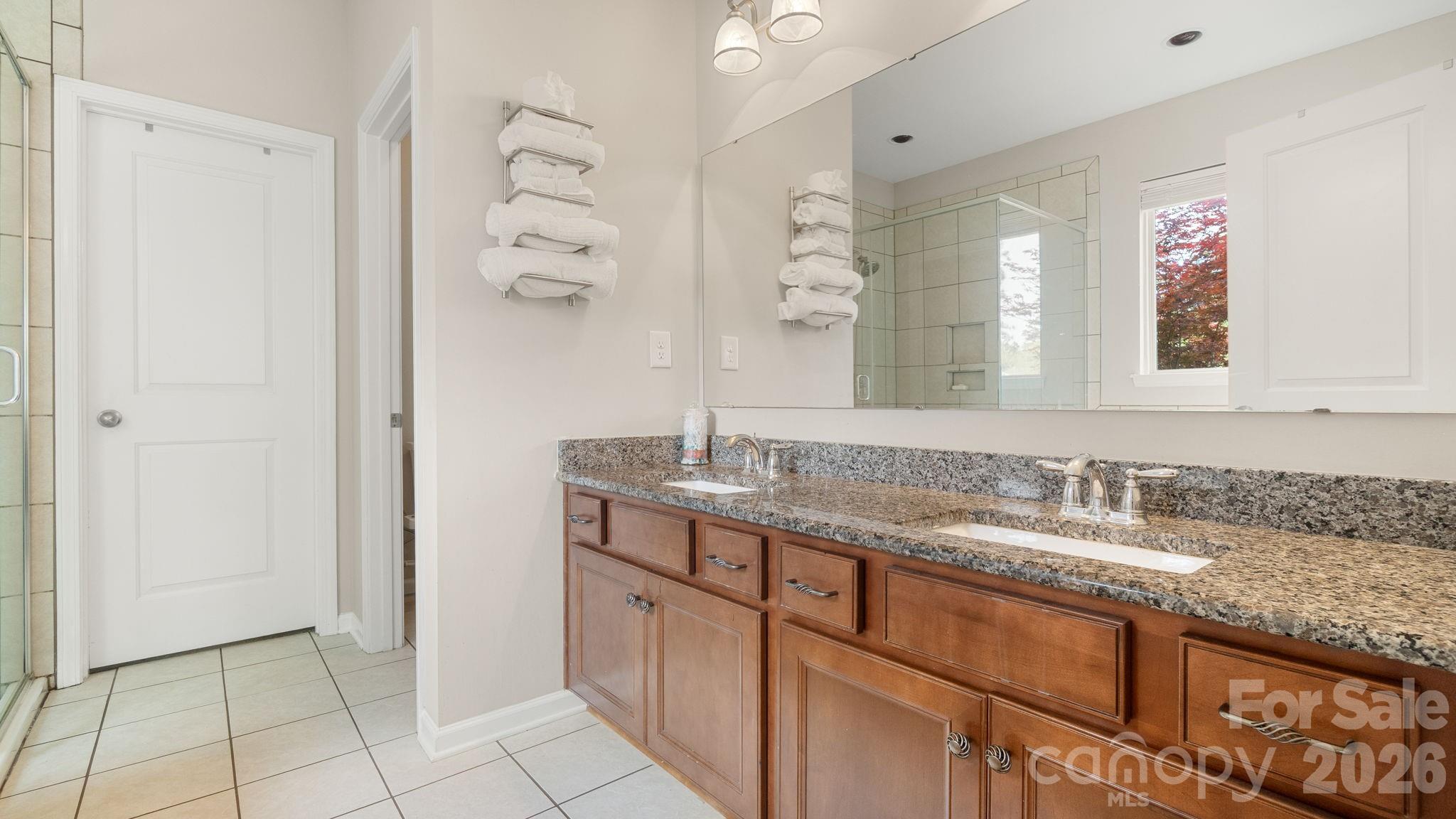 4708 Summerside Drive Clover, SC 29710 - Photo 25 of 48 a bathroom with a granite countertop sink a mirror and a shower