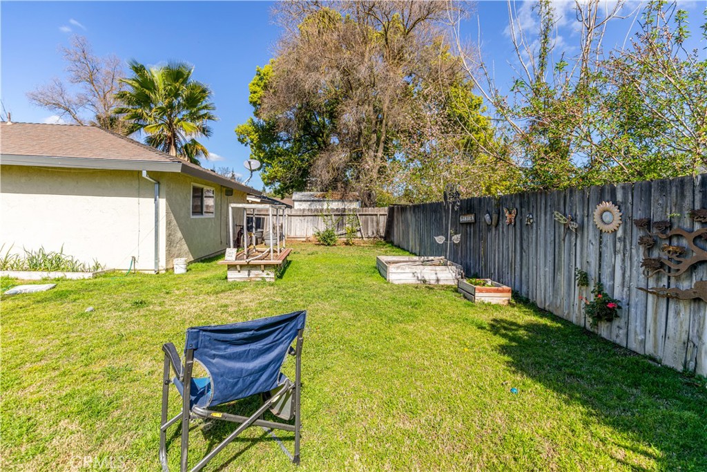 3552 Wathen Court Merced, CA 95348 - Photo 12 of 14 a view of a patio with table and chairs and wooden fence