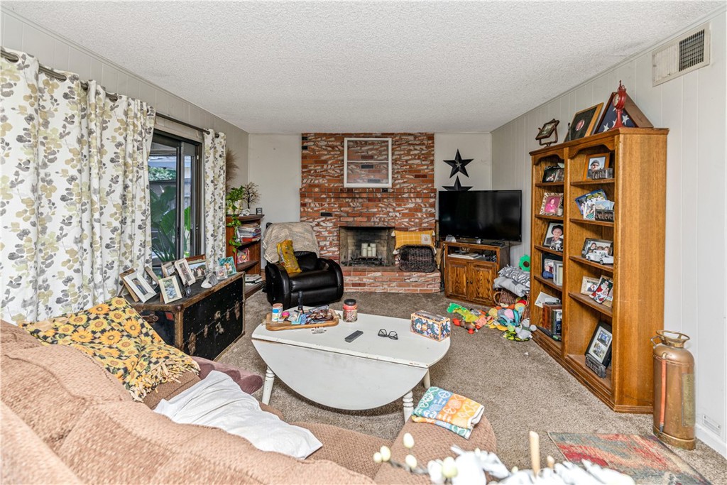 3552 Wathen Court Merced, CA 95348 - Photo 4 of 14 a living room with fireplace furniture and a flat screen tv