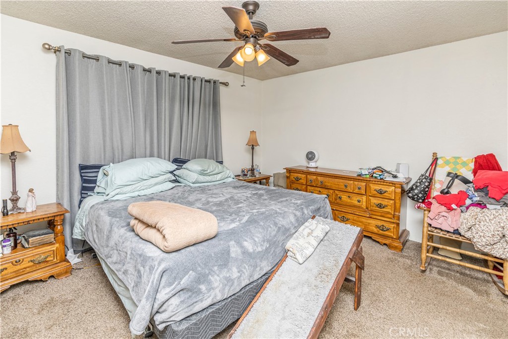 3552 Wathen Court Merced, CA 95348 - Photo 8 of 14 a bedroom with a bed and a chandelier