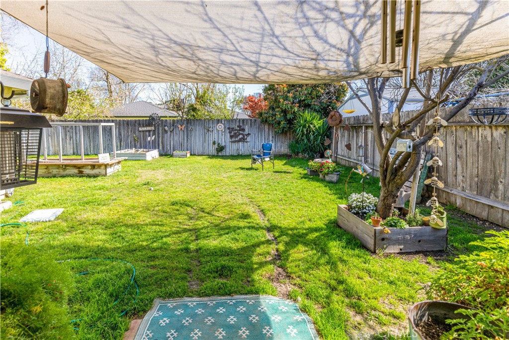 3552 Wathen Court Merced, CA 95348 - Photo 10 of 14 a view of a backyard with table and chairs and wooden fence