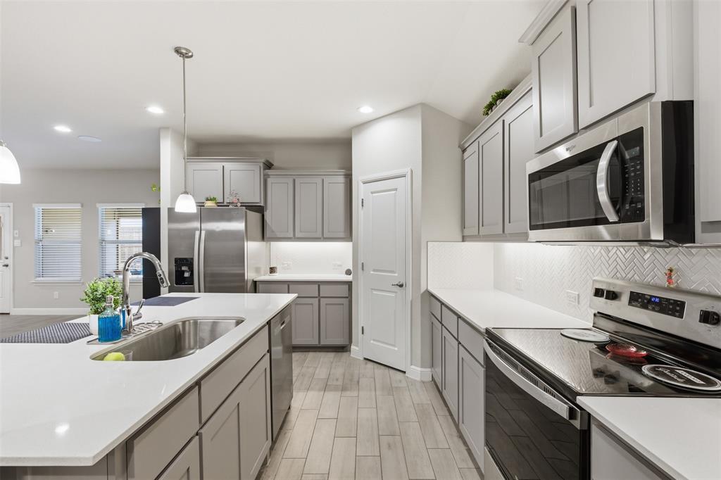 333 Alice Harney Road Burleson, TX 76028 - Photo 1 of 36 a kitchen with stainless steel appliances a sink stove and refrigerator