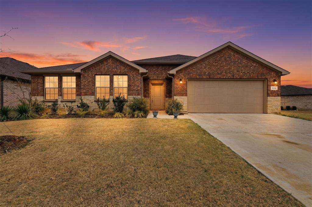 333 Alice Harney Road Burleson, TX 76028 - Photo 13 of 36 a front view of a house with a yard and garage