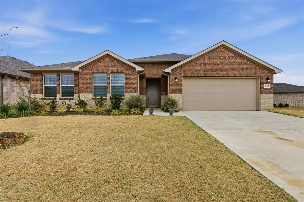 333 Alice Harney Road Burleson, TX 76028 - Photo 17 of 36 a front view of a house with a yard and garage
