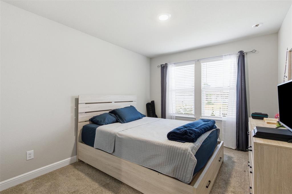 333 Alice Harney Road Burleson, TX 76028 - Photo 20 of 36 a bedroom with a bed and a flat screen tv