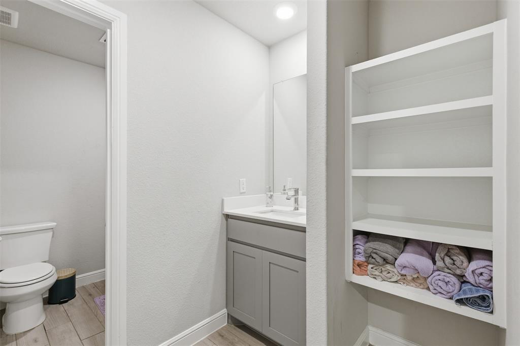 333 Alice Harney Road Burleson, TX 76028 - Photo 23 of 36 a bathroom with a toilet sink and vanity