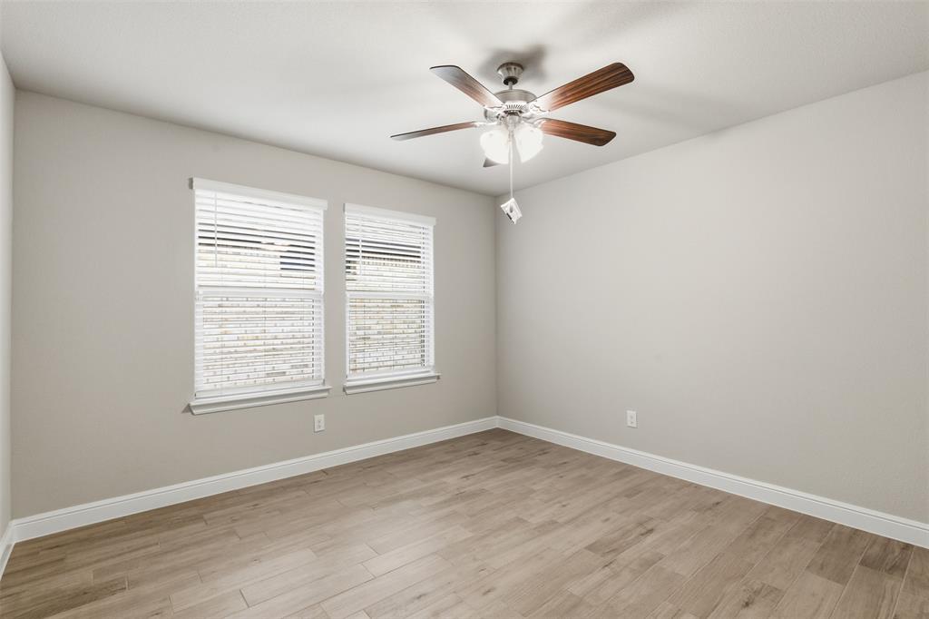 333 Alice Harney Road Burleson, TX 76028 - Photo 25 of 36 an empty room with wooden floor window and ceiling fan