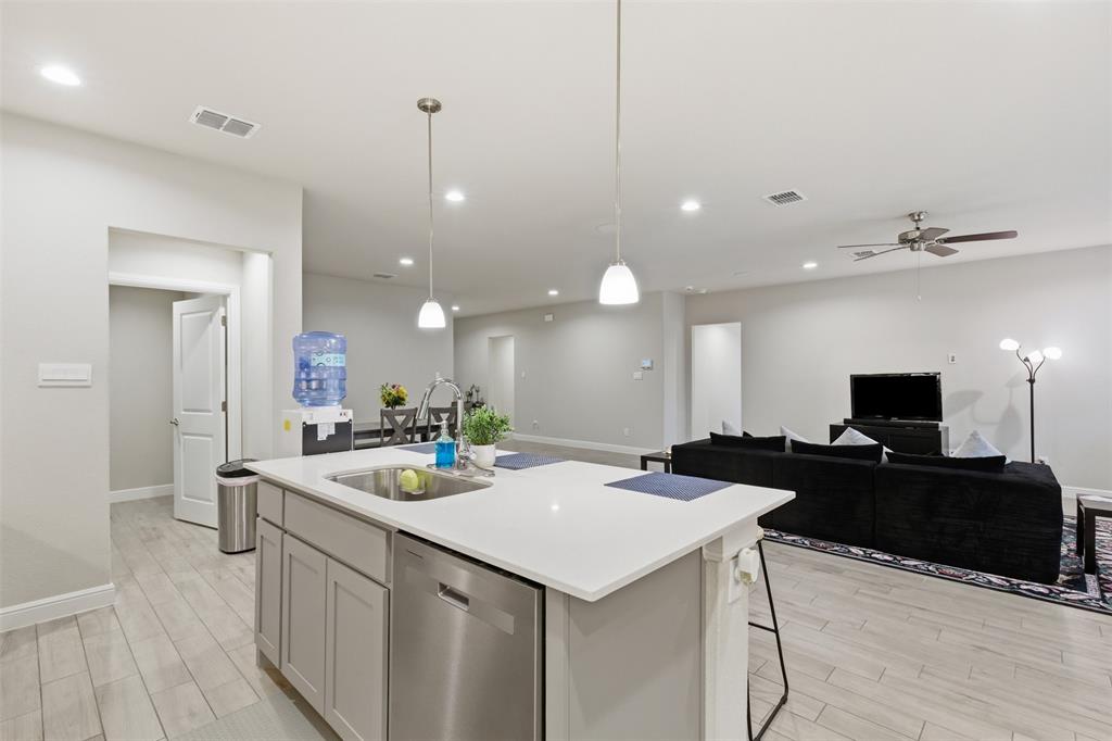 333 Alice Harney Road Burleson, TX 76028 - Photo 3 of 36 a view of a kitchen area kitchen island furniture and a flat screen tv
