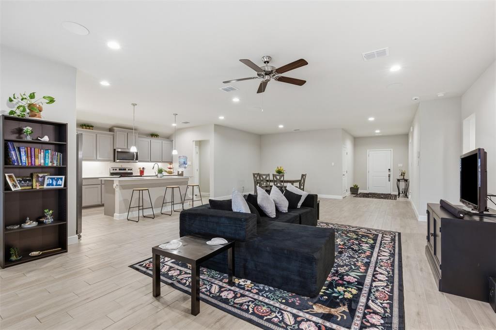 333 Alice Harney Road Burleson, TX 76028 - Photo 4 of 36 a living room with furniture and a flat screen tv