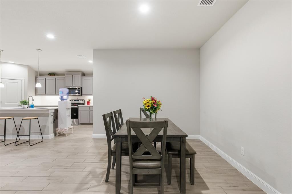333 Alice Harney Road Burleson, TX 76028 - Photo 7 of 36 a view of a dining room with furniture and wooden floor