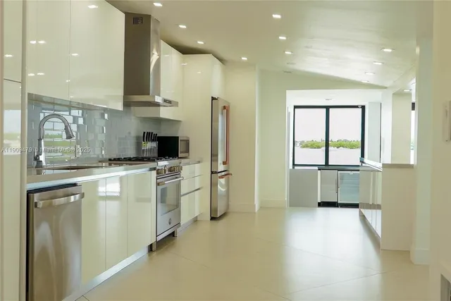 a kitchen with a refrigerator and a sink
