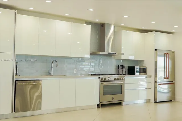 a kitchen with a sink stainless steel appliances and cabinets
