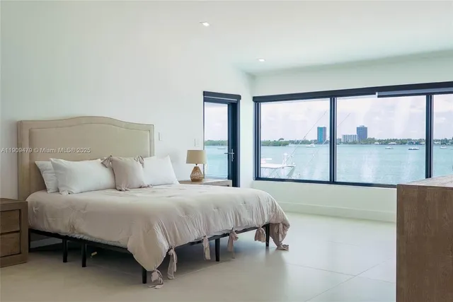 a bedroom with a large bed and a large window