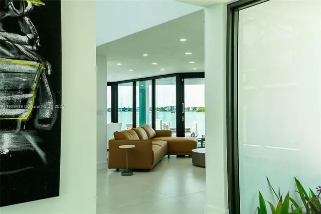 a living room with furniture and a floor to ceiling window