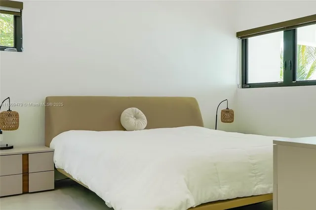 a bedroom with a bed and window