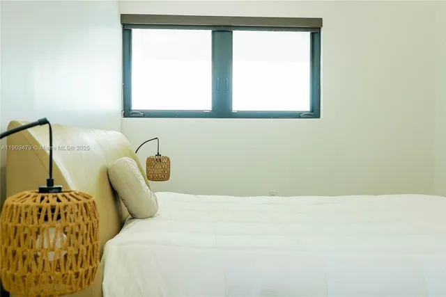 a bedroom with a bed and window