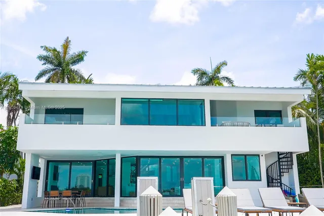 a view of house with a swimming pool and outdoor seating