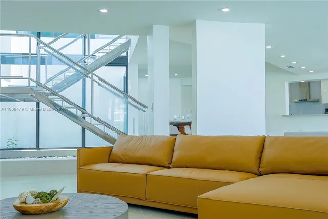 a living room with furniture a mirror and a ceiling fan