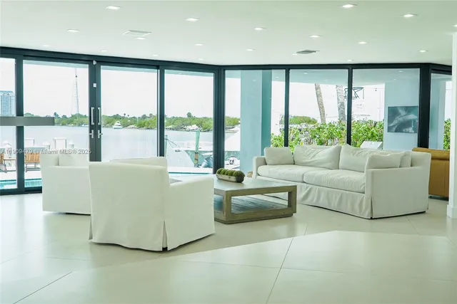 a living room with furniture and large windows