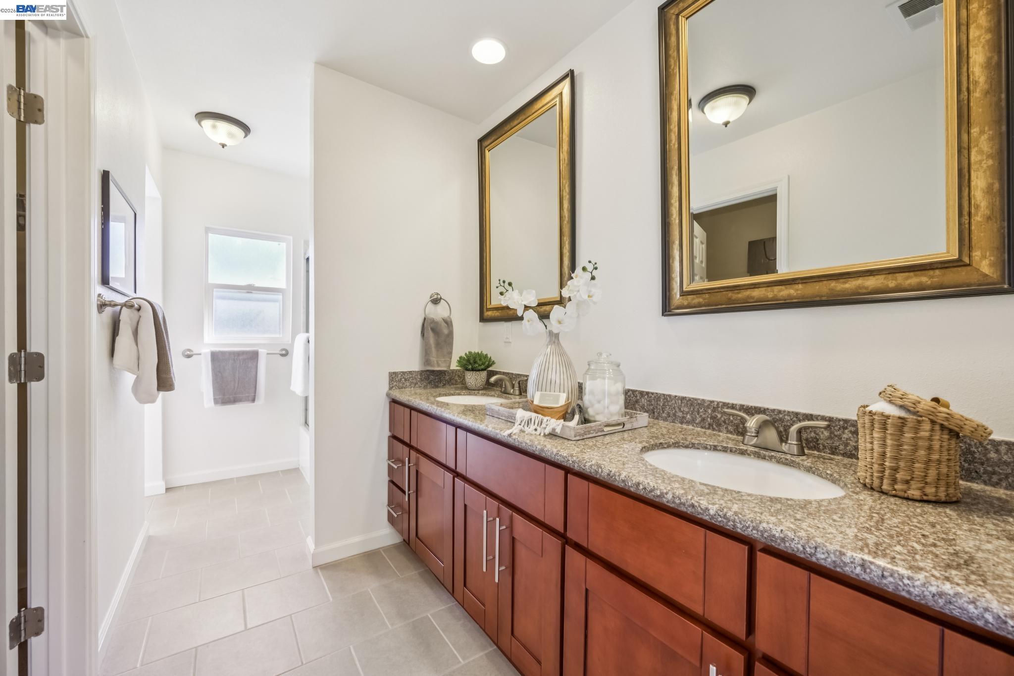 21132 Tyee Court Castro Valley, CA 94546 - Photo 21 of 60 a bathroom with a granite countertop sink and a mirror