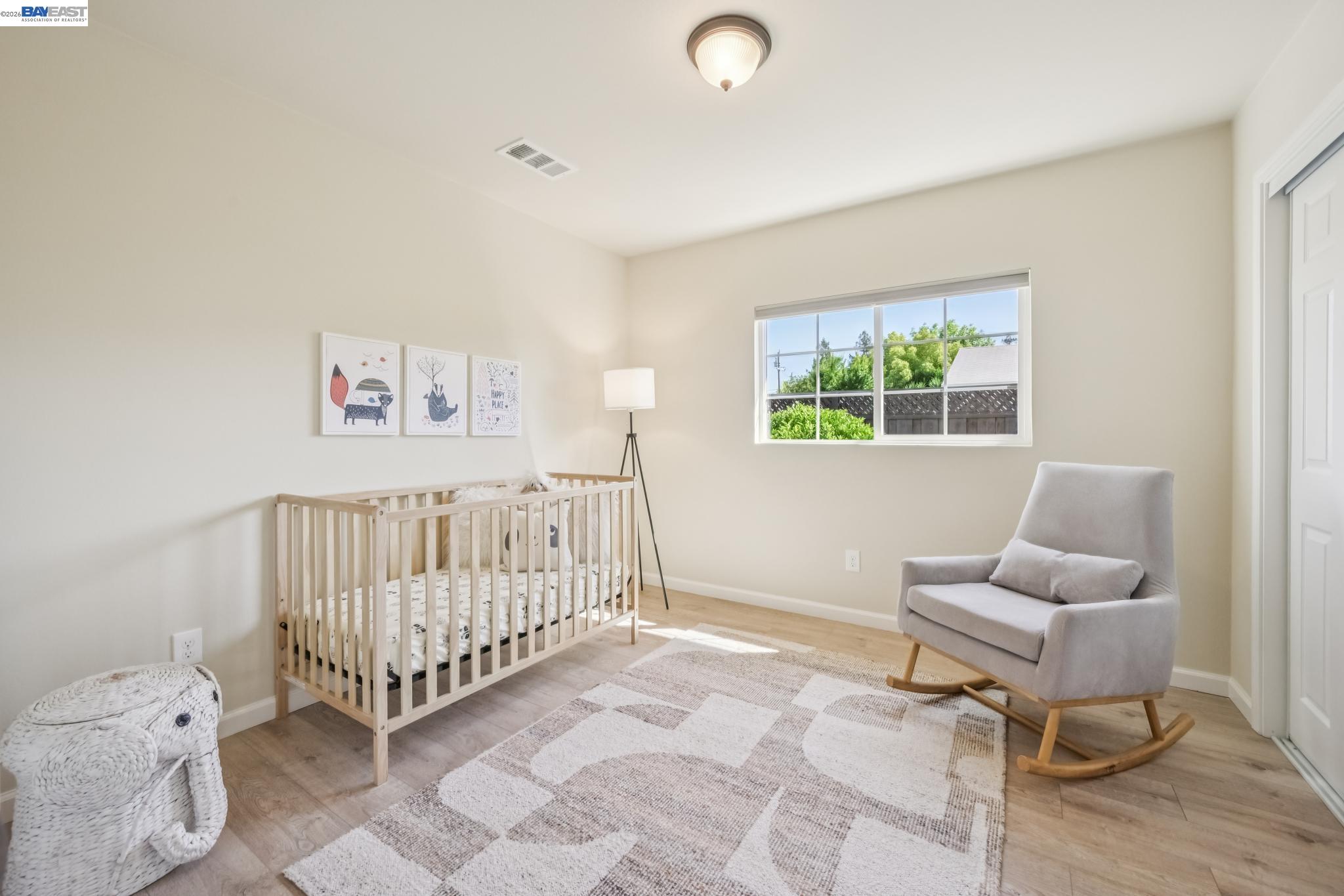 21132 Tyee Court Castro Valley, CA 94546 - Photo 25 of 60 a bedroom with a baby bed a couch and a window