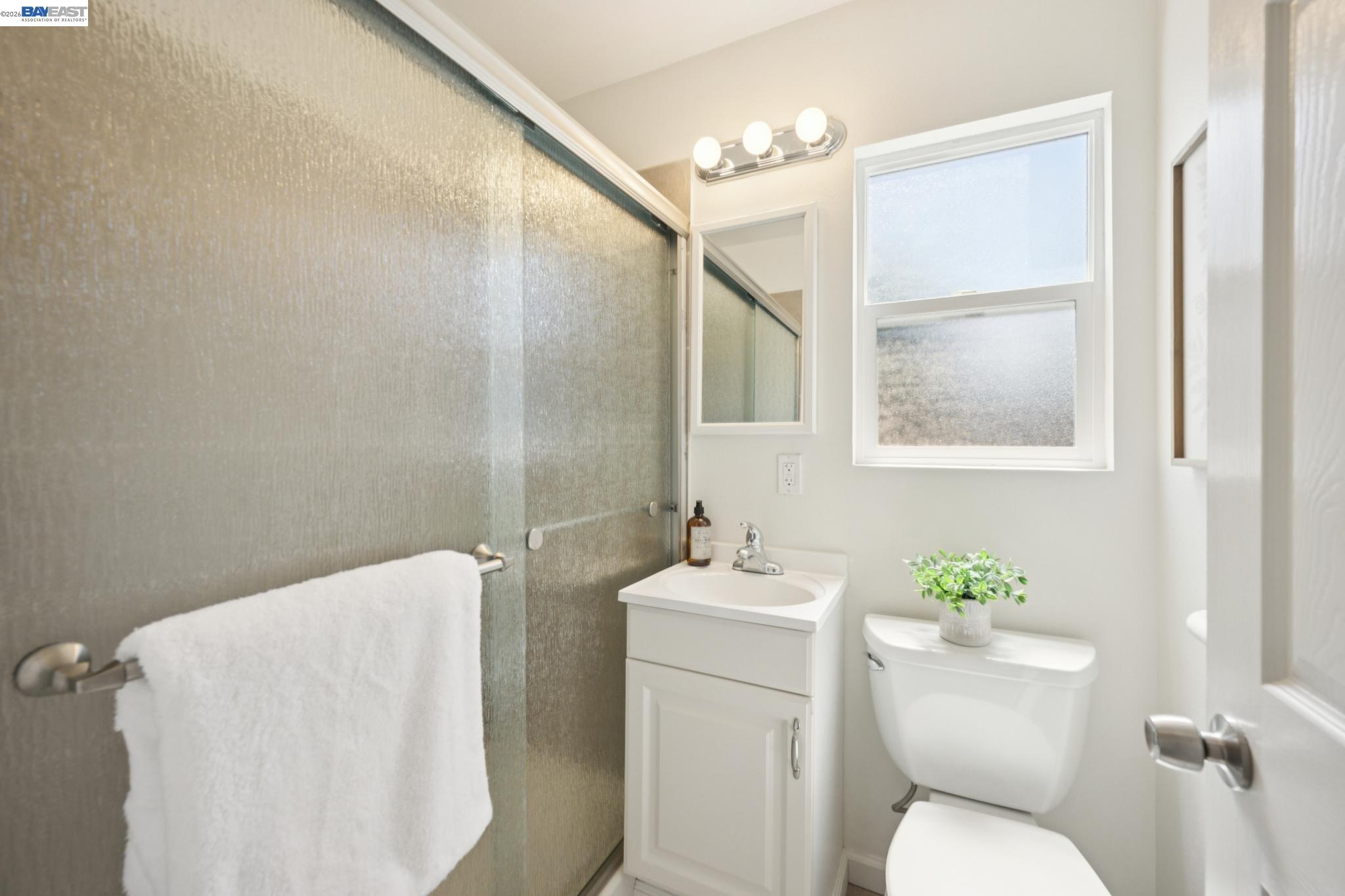 21132 Tyee Court Castro Valley, CA 94546 - Photo 34 of 60 a bathroom with a toilet sink and mirror