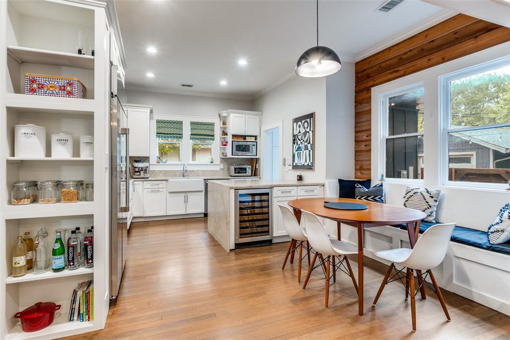 5235 Goodwin Avenue Dallas, TX 75206 - Photo 12 of 31 a kitchen with a dining table chairs and white cabinets