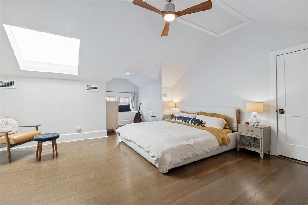 5235 Goodwin Avenue Dallas, TX 75206 - Photo 20 of 31 a bedroom with a bed and a chair