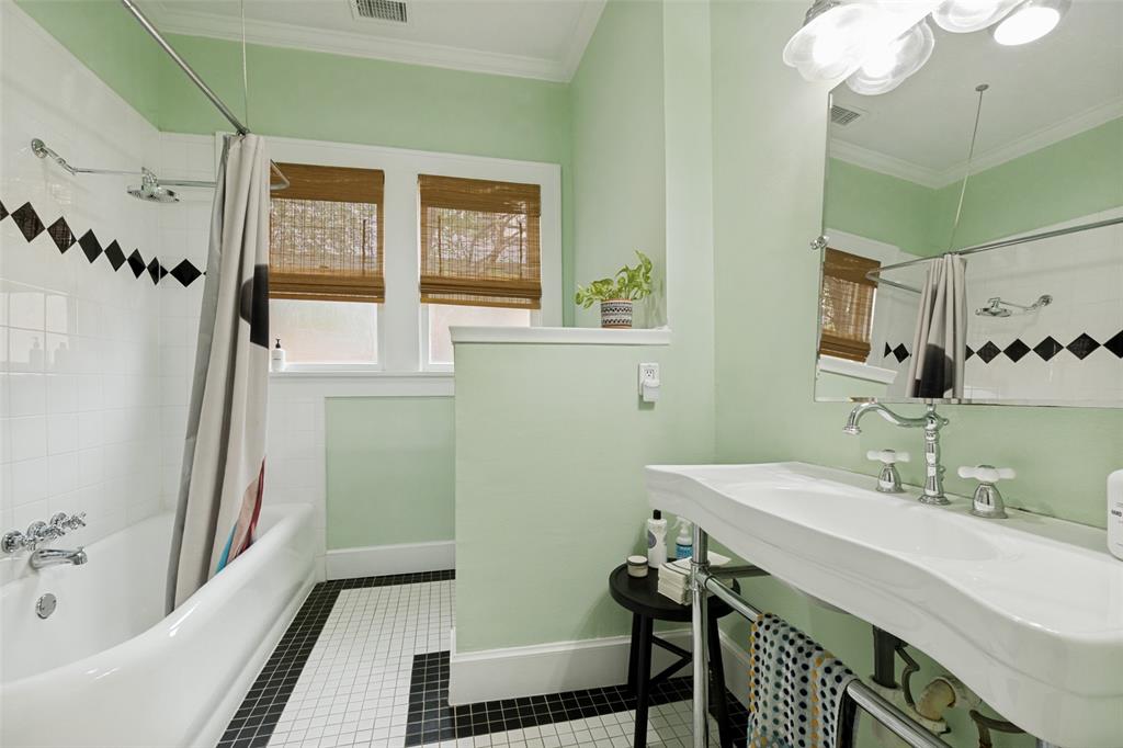 5235 Goodwin Avenue Dallas, TX 75206 - Photo 26 of 31 a bathroom with a sink mirror and a bathtub