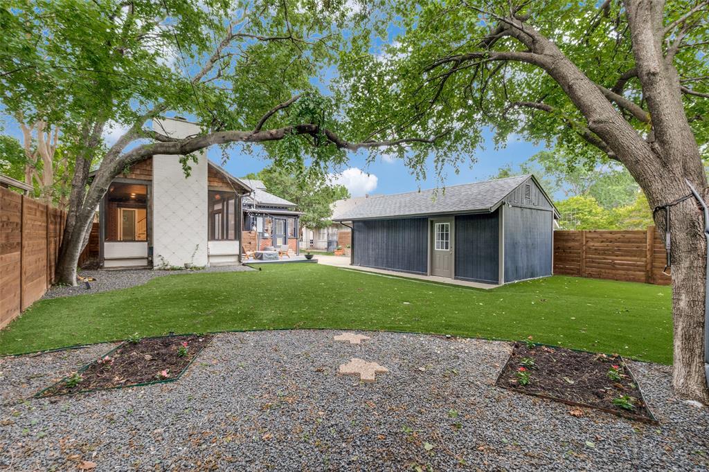 5235 Goodwin Avenue Dallas, TX 75206 - Photo 29 of 31 a front view of a house with a garden and trees