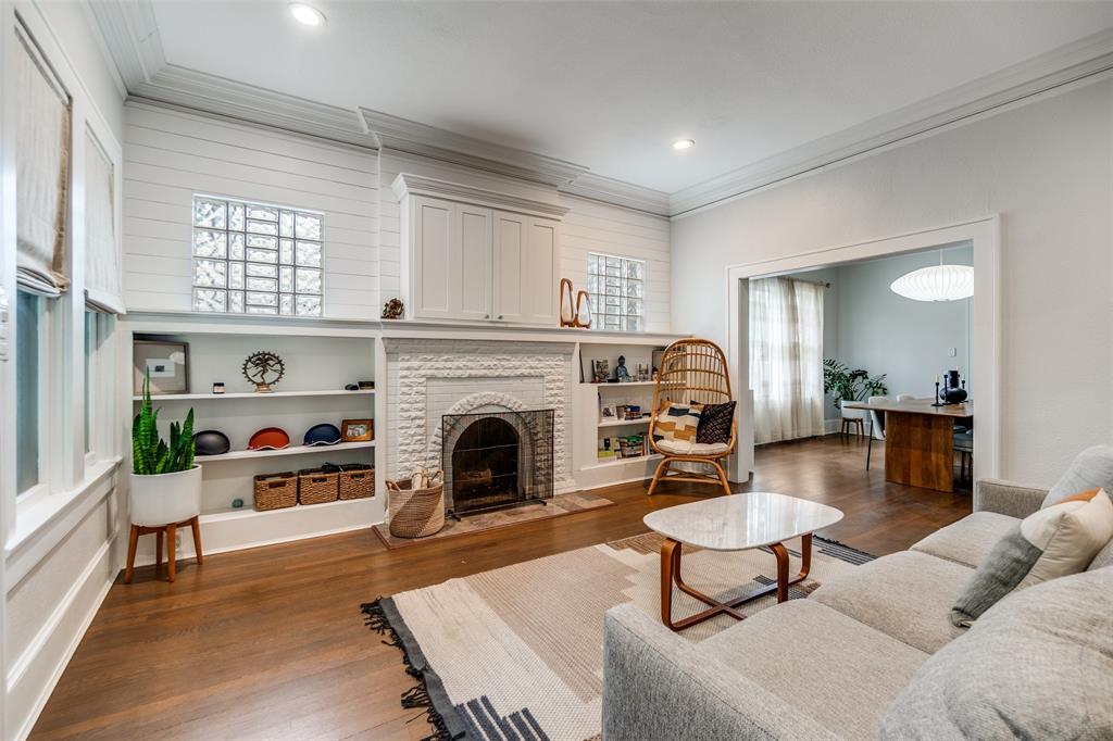 5235 Goodwin Avenue Dallas, TX 75206 - Photo 3 of 31 a living room with furniture a fireplace and a table