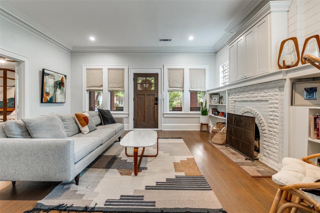 5235 Goodwin Avenue Dallas, TX 75206 - Photo 4 of 31 a living room with furniture and a fireplace