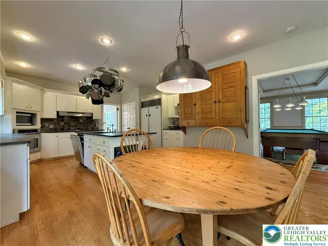 a bedroom with a bed and a dresser with mirror