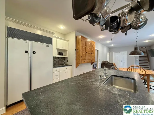 a bathroom with a tub sink toilet and mirror
