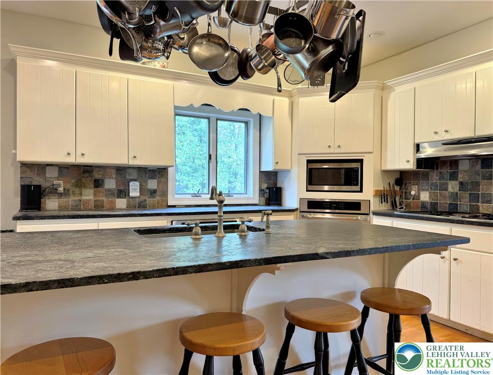 1997 West Point Drive Bethlehem, PA 18015 - Photo 32 of 94 a kitchen with stainless steel appliances granite countertop a stove a sink and a microwave