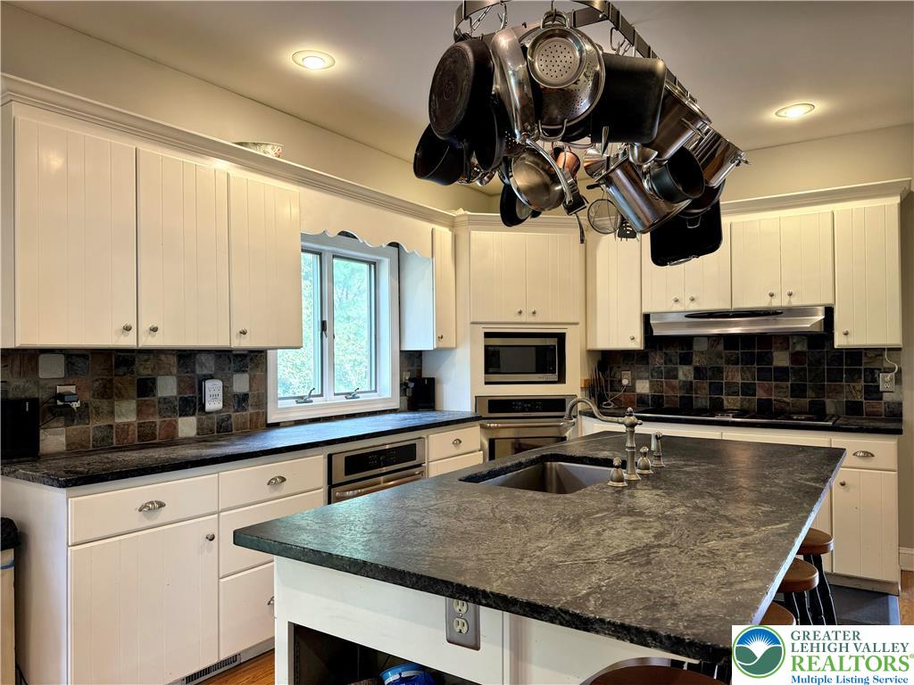 1997 West Point Drive Bethlehem, PA 18015 - Photo 35 of 94 a kitchen with stainless steel appliances granite countertop a sink a stove and cabinets