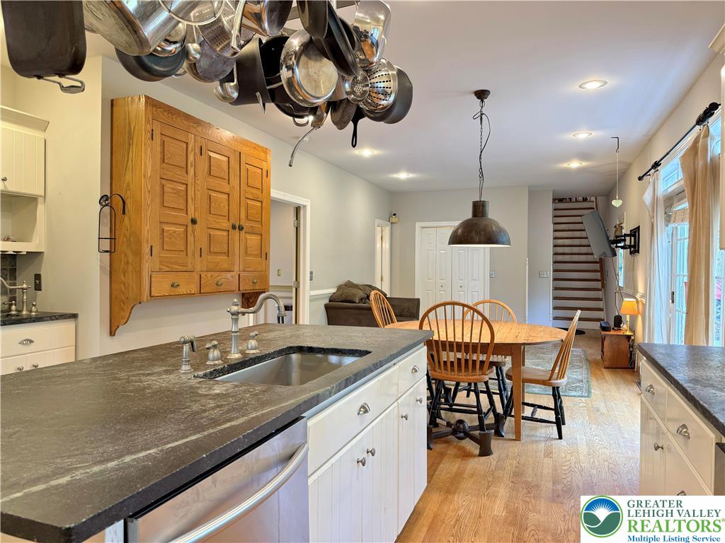 1997 West Point Drive Bethlehem, PA 18015 - Photo 36 of 94 a kitchen with stainless steel appliances a table chairs and chandelier
