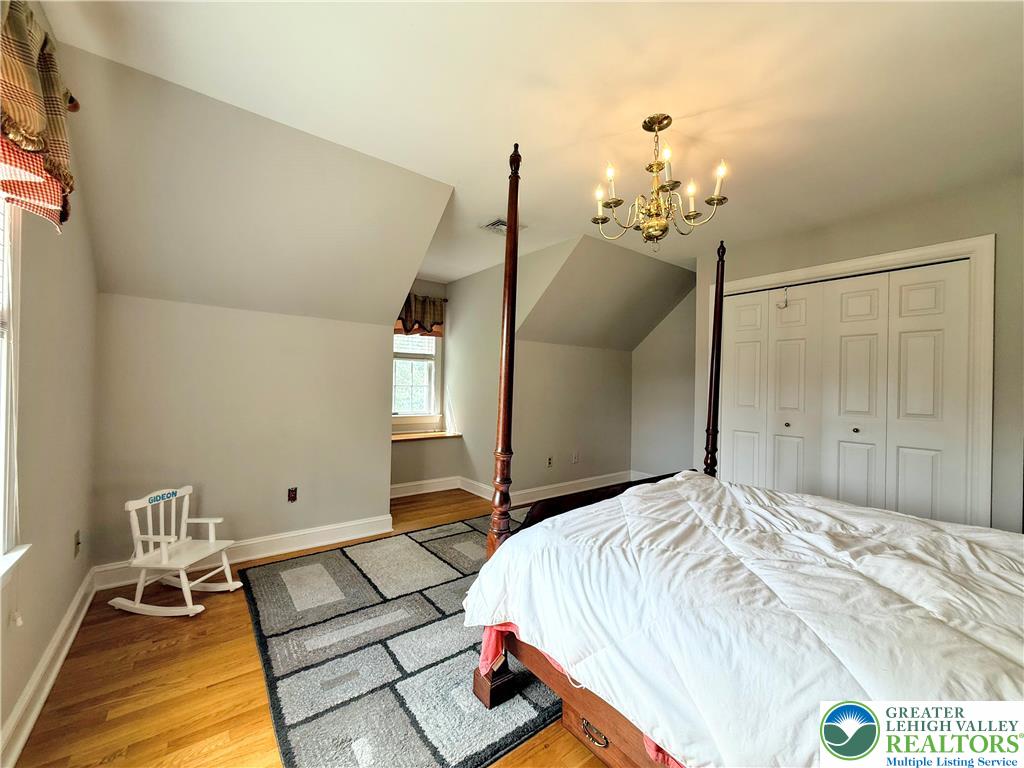 1997 West Point Drive Bethlehem, PA 18015 - Photo 75 of 94 a bedroom with a bed and a chandelier