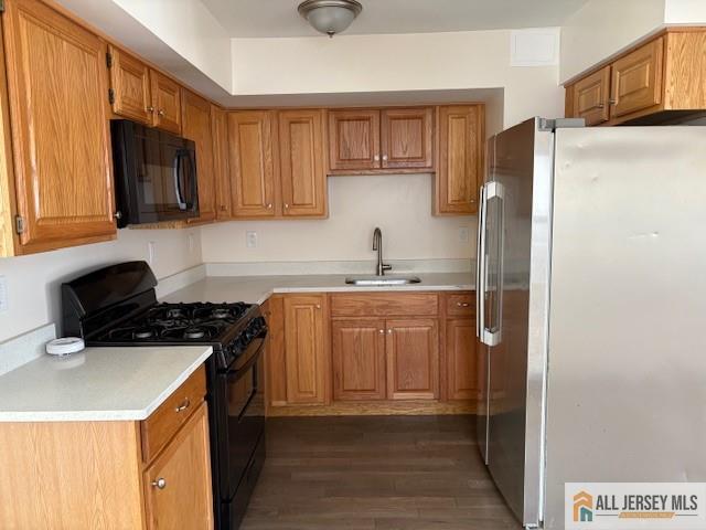 327 Leon Avenue, Unit 1 Perth Amboy, NJ 08861 - Photo 12 of 20 a kitchen with sink a refrigerator and cabinets