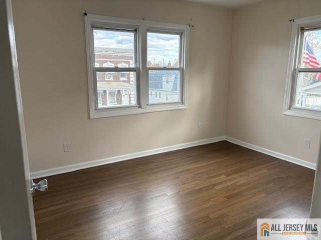 327 Leon Avenue, Unit 1 Perth Amboy, NJ 08861 - Photo 15 of 20 an empty room with wooden floor and windows