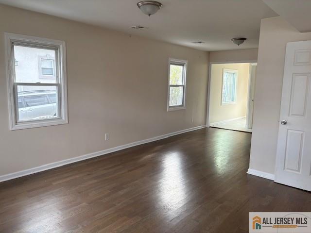 327 Leon Avenue, Unit 1 Perth Amboy, NJ 08861 - Photo 6 of 20 a view of an empty room with wooden floor and a window