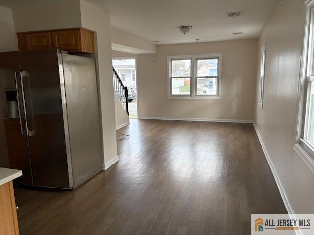 327 Leon Avenue, Unit 1 Perth Amboy, NJ 08861 - Photo 7 of 20 an empty room with wooden floor cabinet and windows