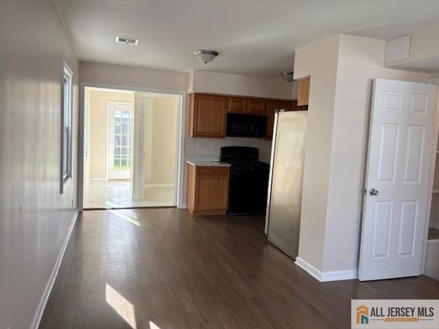 327 Leon Avenue, Unit 1 Perth Amboy, NJ 08861 - Photo 10 of 20 a kitchen with stainless steel appliances a refrigerator and wooden floor
