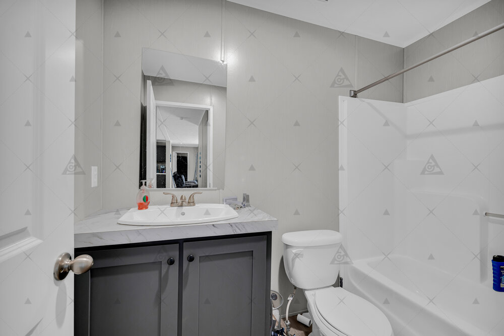 107 Clearwater Shores Road Fair Play, SC 29643 - Photo 9 of 23 Laminate countertops and a tub-shower combination anchor this functional secondary bathroom.