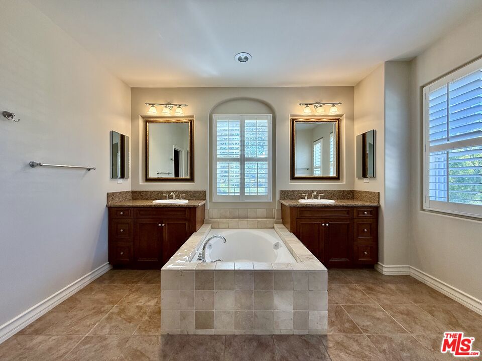 68 Cornflower Irvine, CA 92620 - Photo 11 of 21 a spacious bathroom with a granite countertop tub sink and mirror