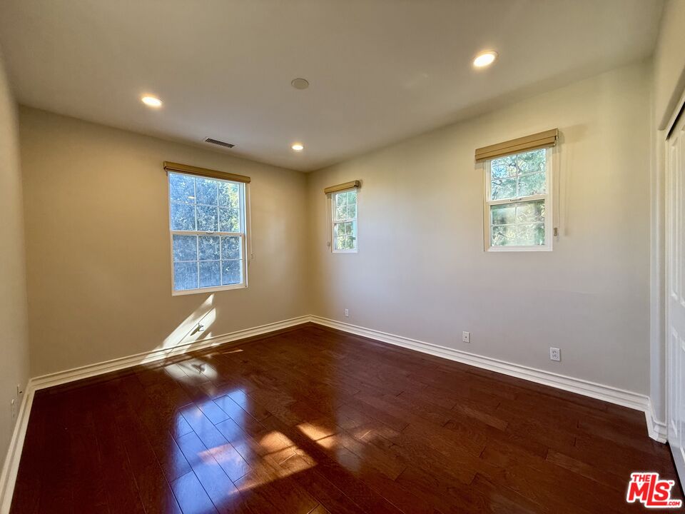 68 Cornflower Irvine, CA 92620 - Photo 14 of 21 an empty room with wooden floor and windows